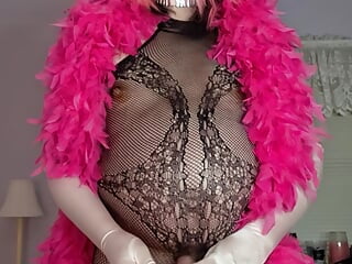 Black fishnet body stocking and pink feather boa, ass stuffed with pink vibrater