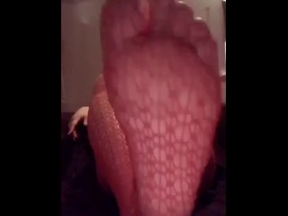 Feet in red fishnets