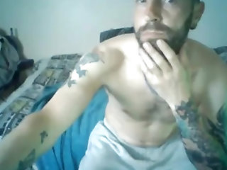 handsome sexy tattooed guy jerking his cock