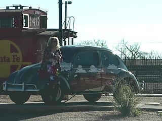 Mrs Samantha 'standing on the corner in Winslow Arizona' and driving her red Mustang Convertible