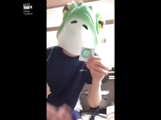 frog mask man jerking with condom and swimming suit